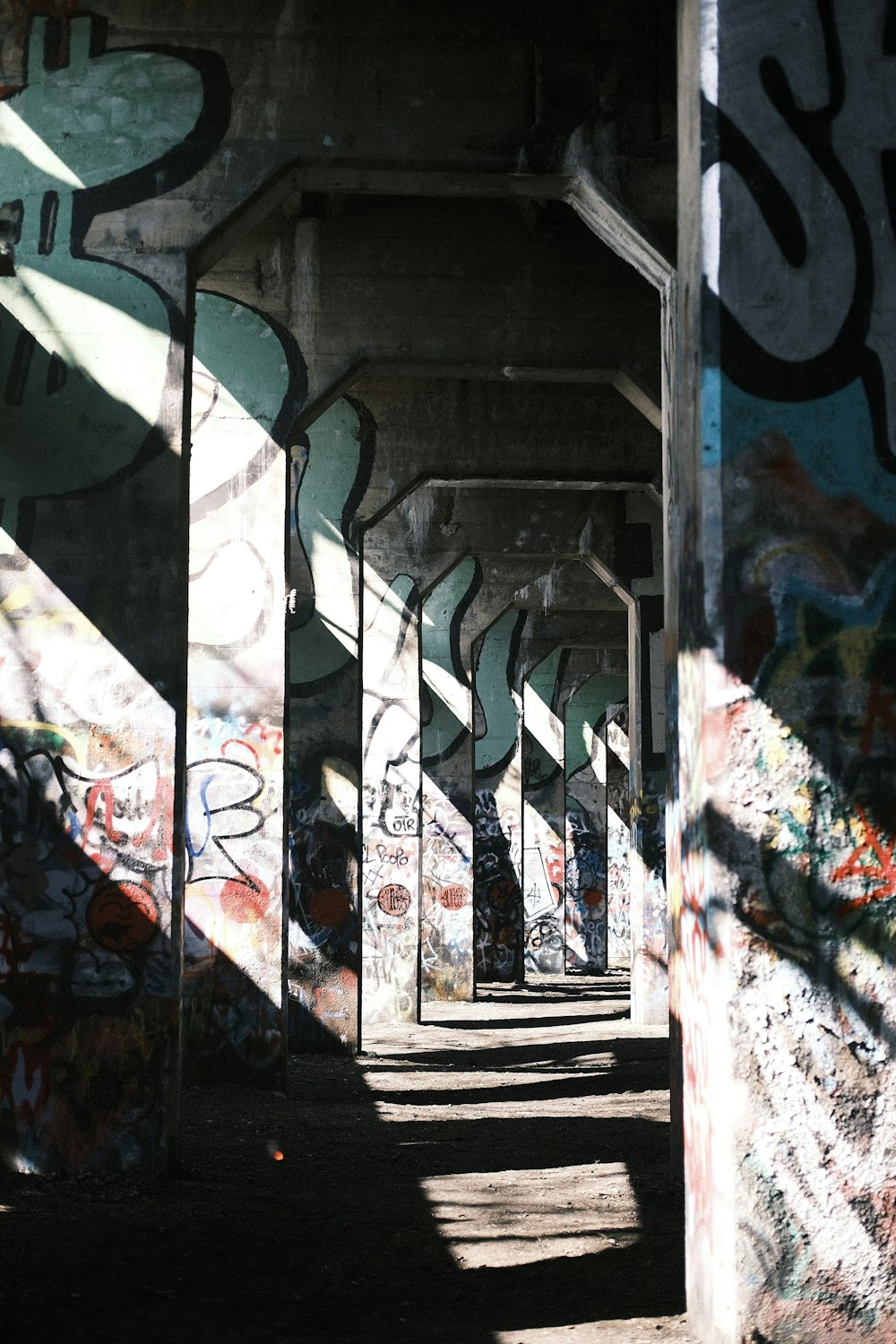 a bunch of graffiti on the side of a building