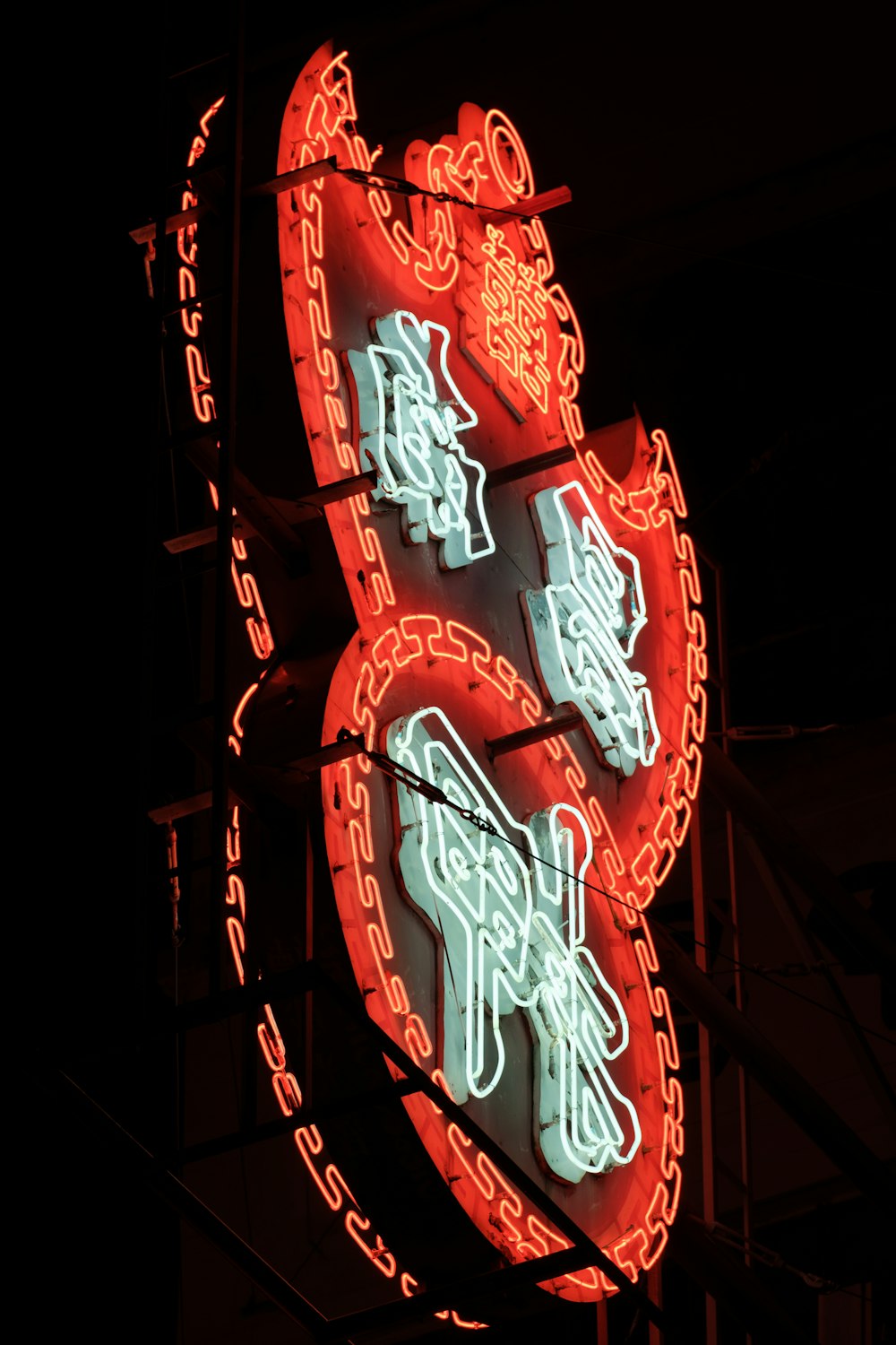 a neon sign with chinese writing on it