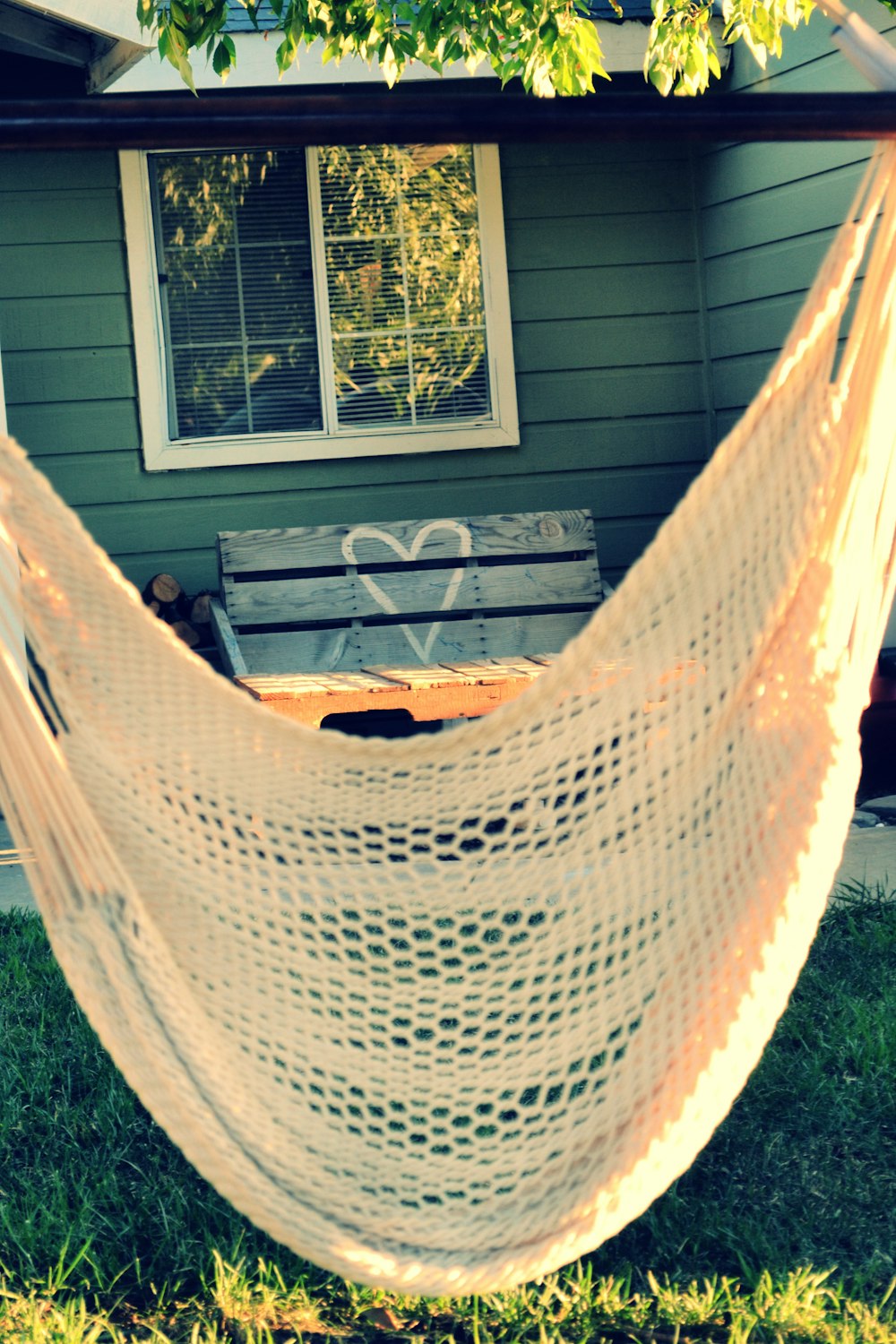 a hammock hanging in front of a house
