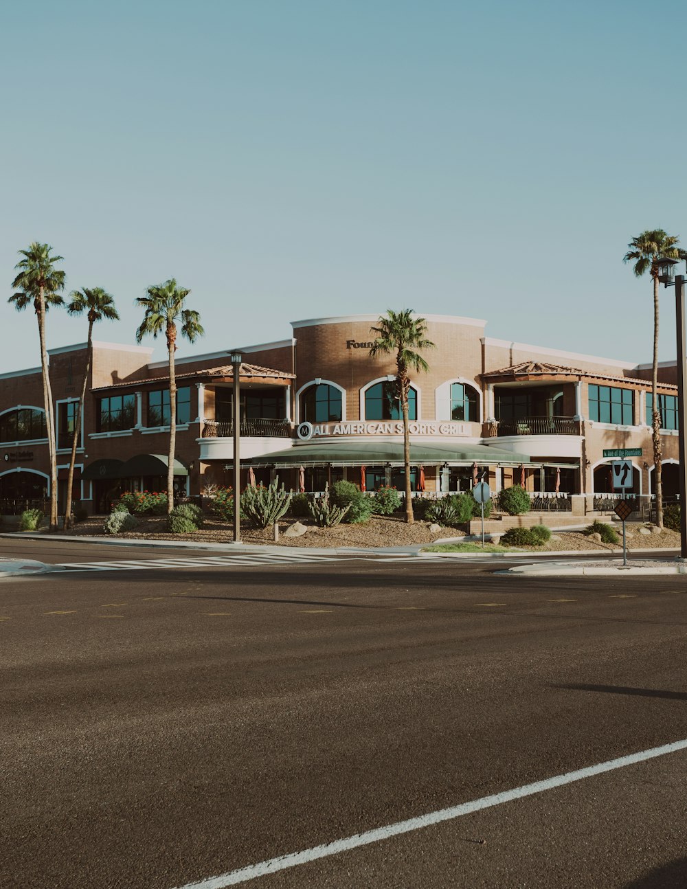 a large building with palm trees in front of it