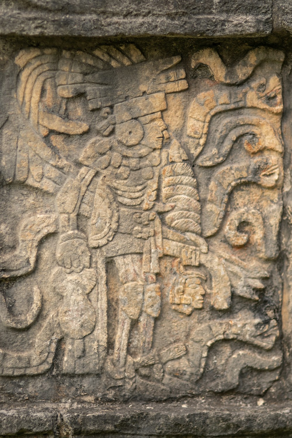 a carving of a man riding an elephant on a stone wall