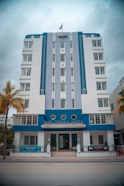 Hotel exterior showing a welcoming blue and white facade reflecting the brand colors.