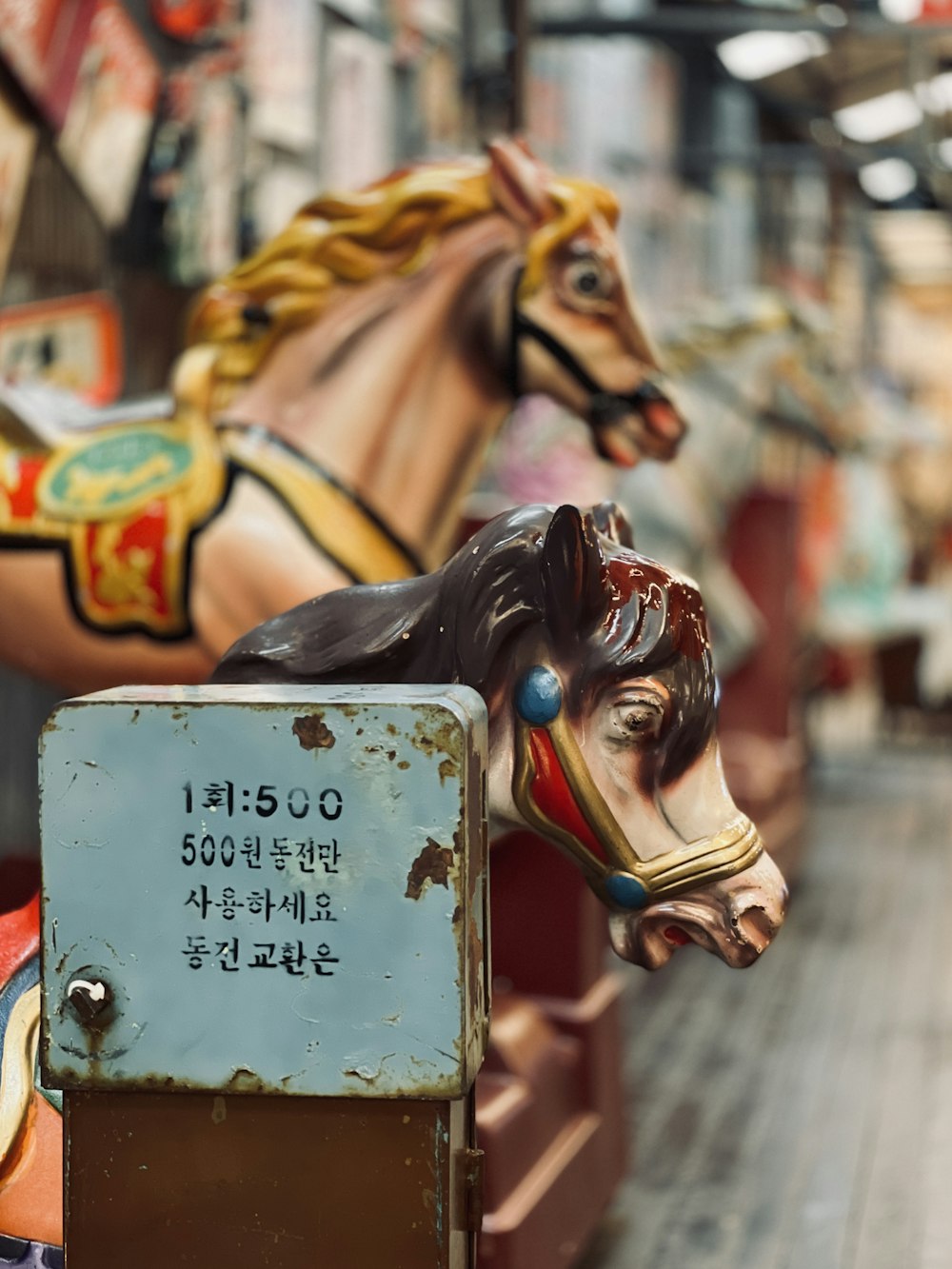 a close up of a horse head on a carousel