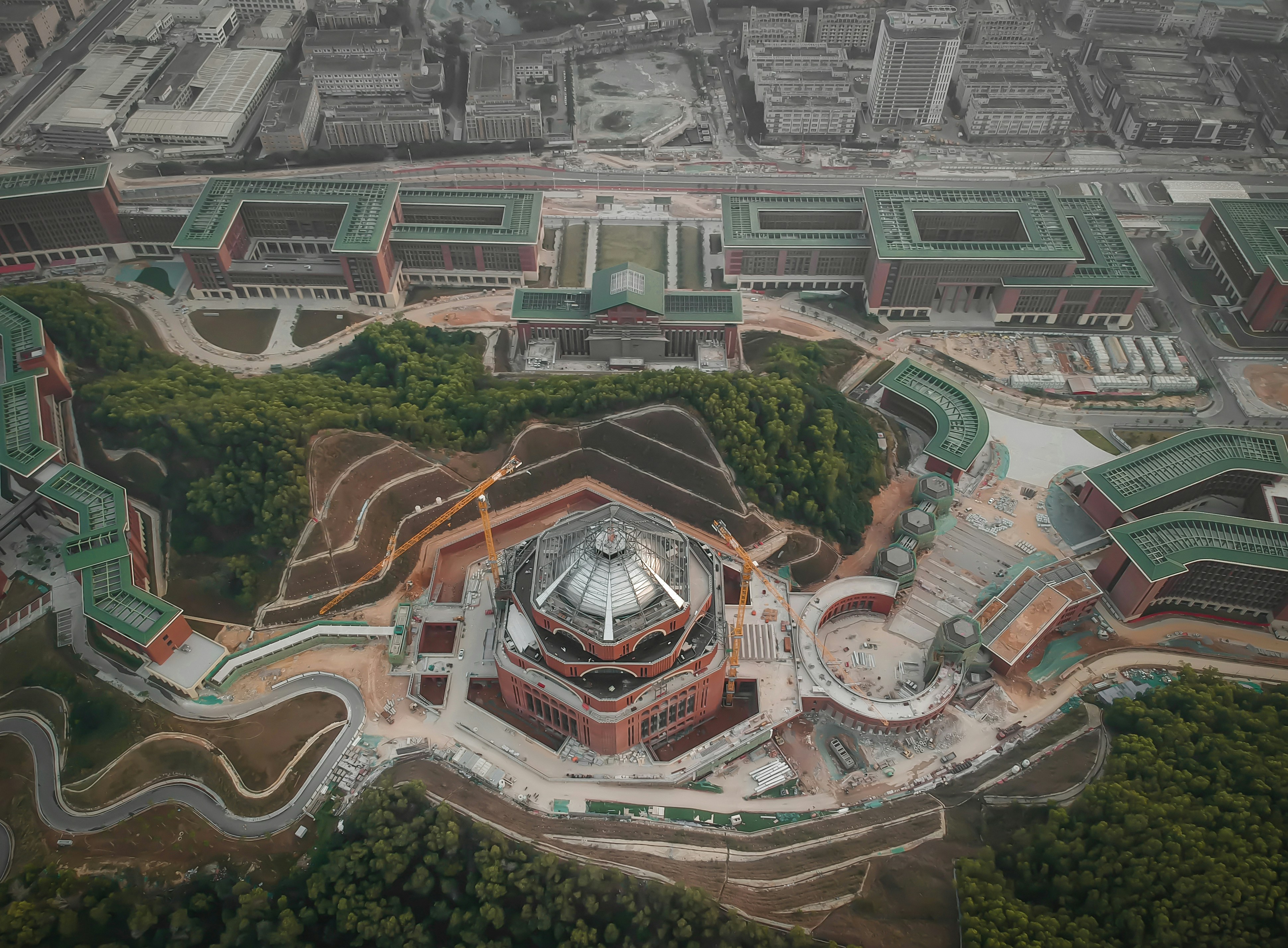 an aerial view of a building surrounded by trees