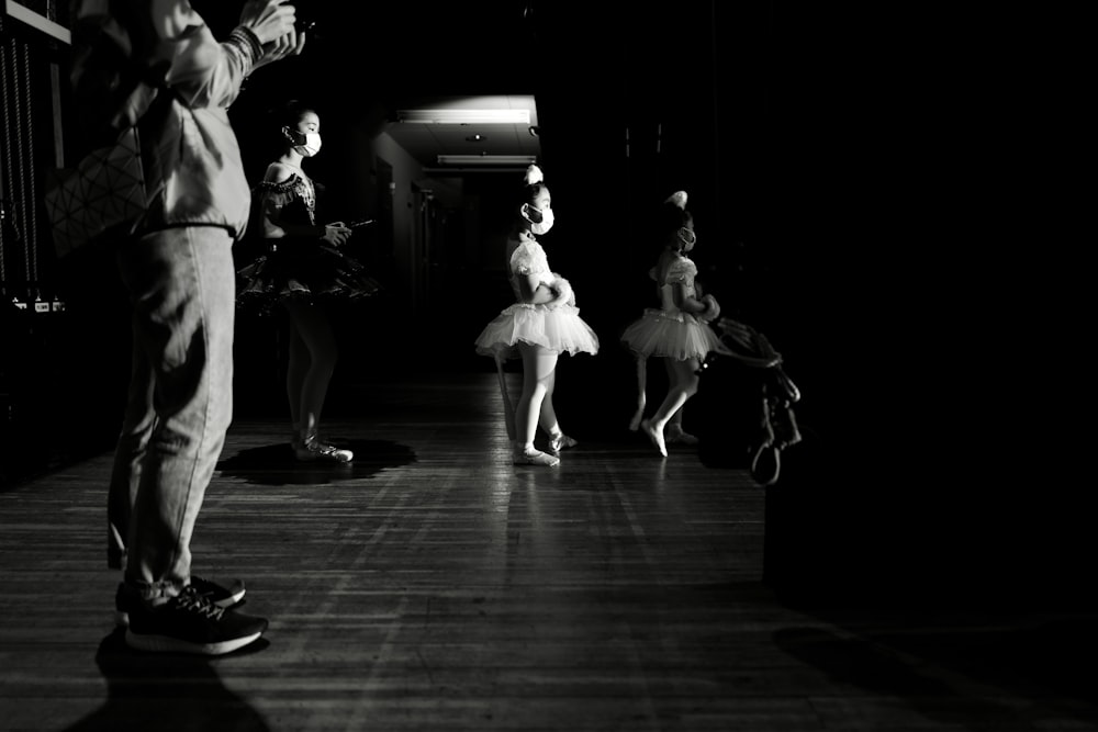 a group of people that are standing in the dark