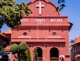 a red building with a white cross on it