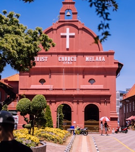 a red building with a white cross on it