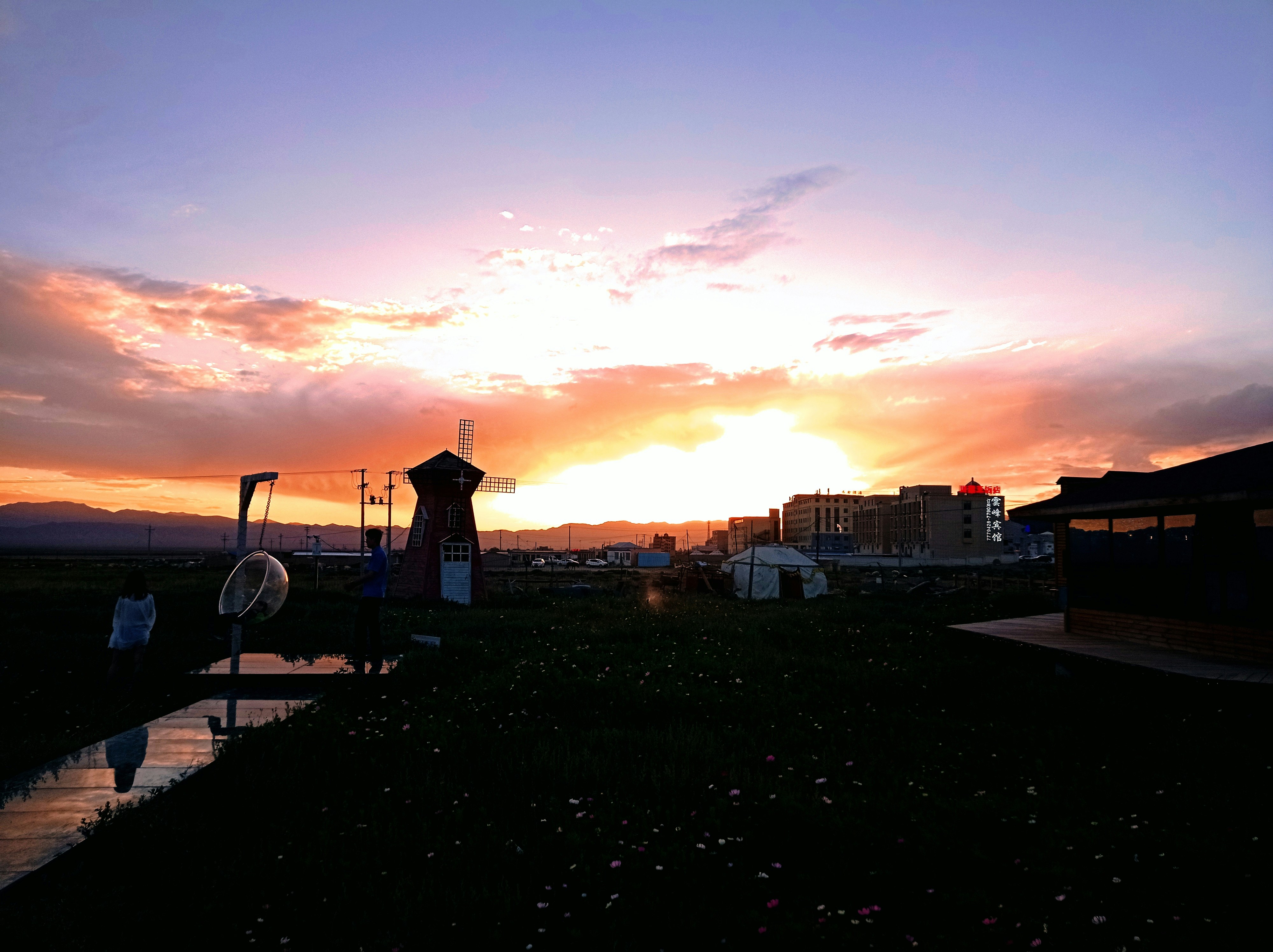 the sun is setting over a small town