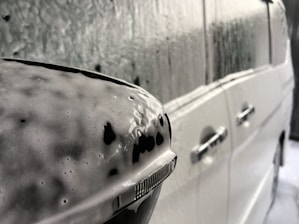 a close up of a white car with black spots