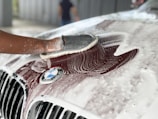 a person washing a car with a sponge