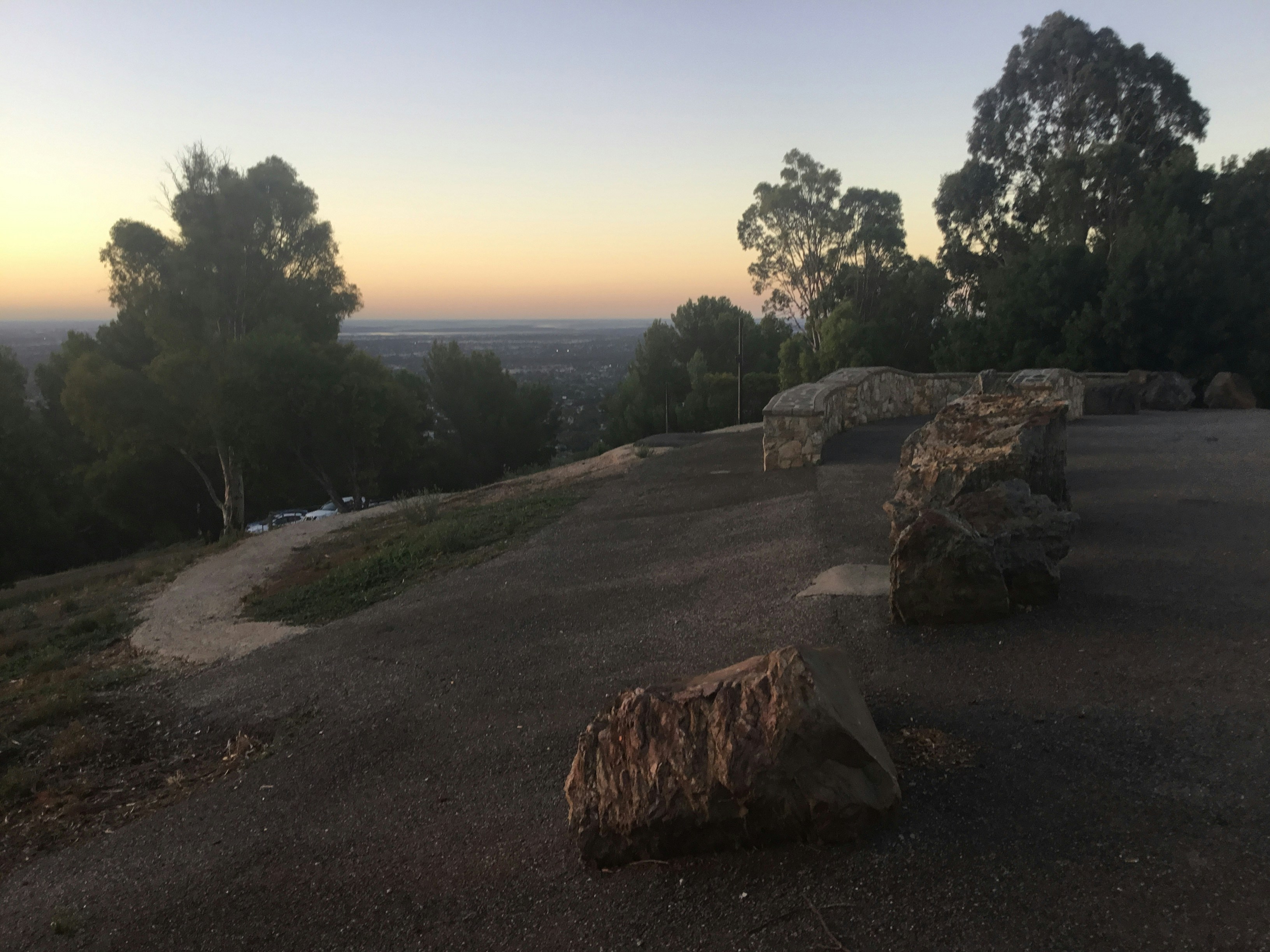 a couple of benches sitting on top of a hill