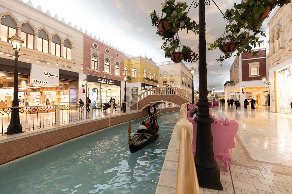 a gondola on a canal in a shopping district