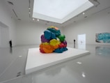 A colorful abstract painting displayed in an art gallery.