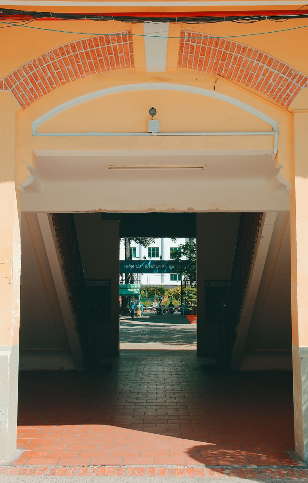 a brick walkway leading to a building with a clock on it