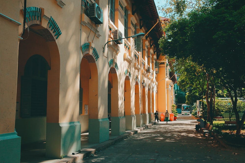 a person sitting on a bench in front of a building