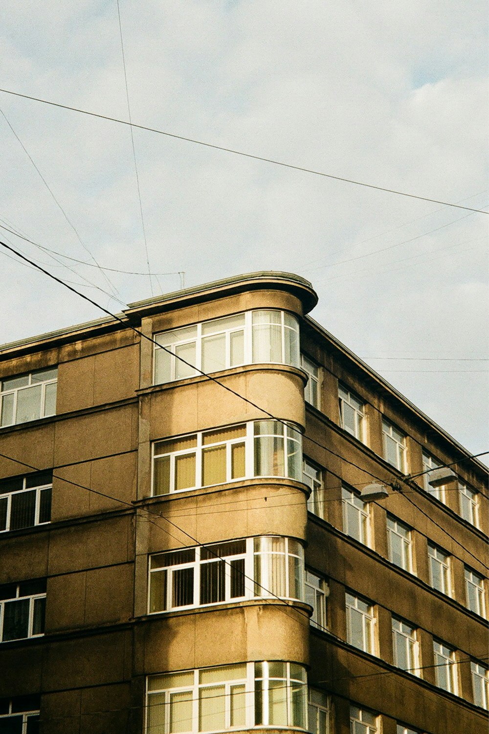 a tall brown building with lots of windows