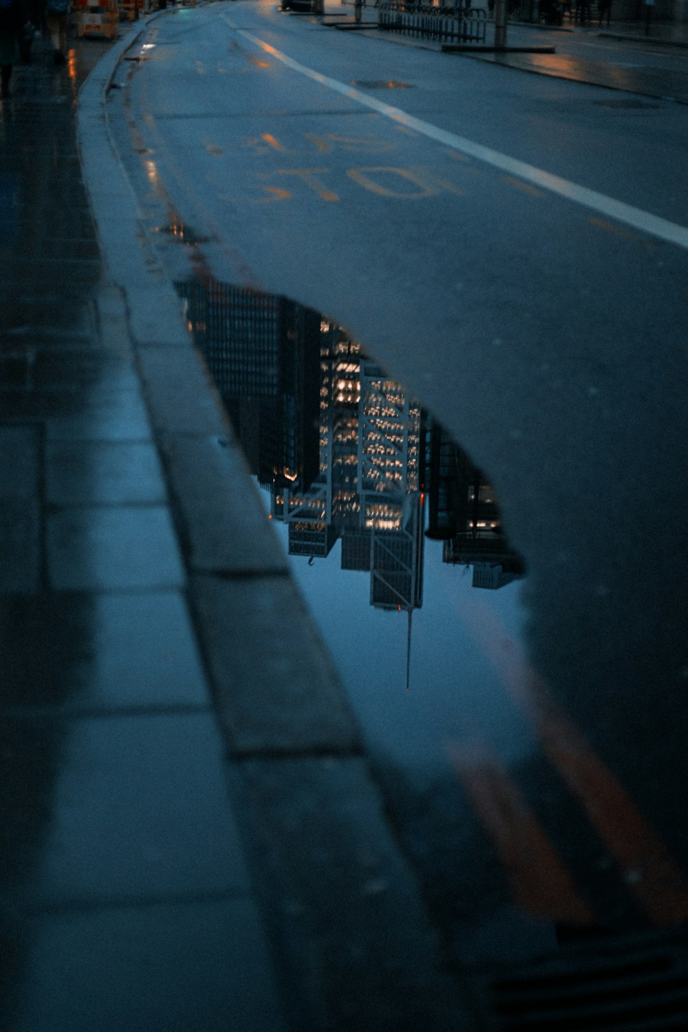 a reflection of a city in a puddle of water