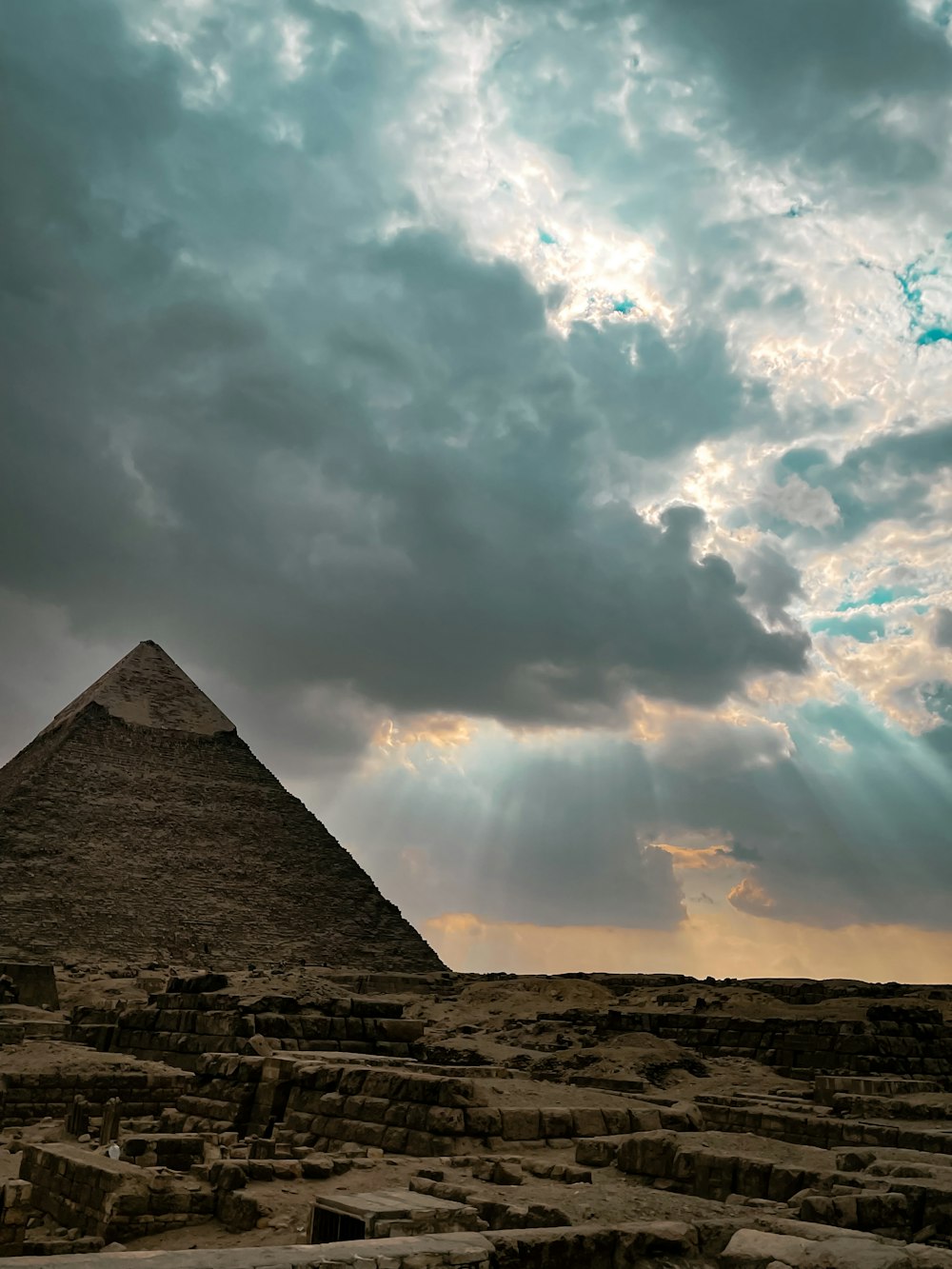 a very tall pyramid under a cloudy sky