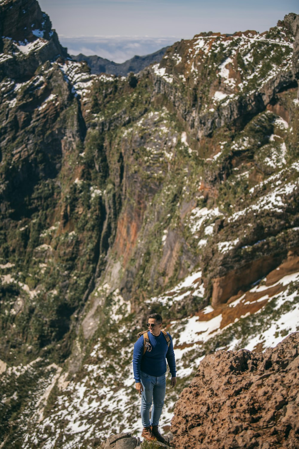 a man standing on top of a snow covered mountain