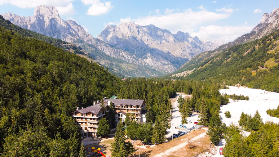 Aerial view of a mountain resort surrounded by forested ridges