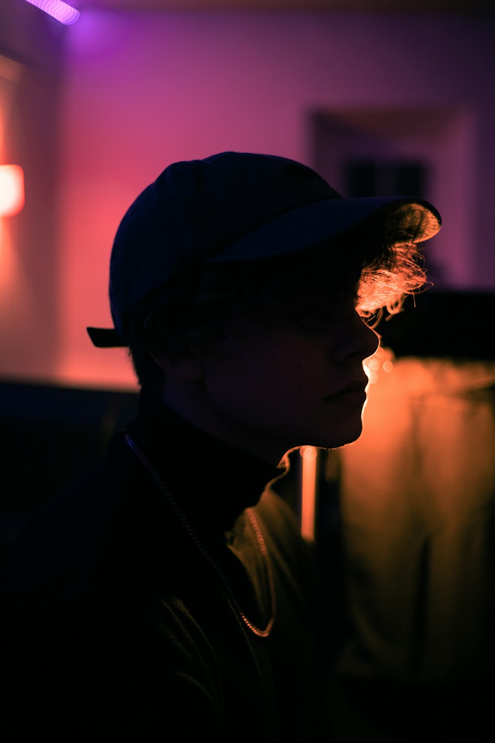 a person wearing a hat in a dark room