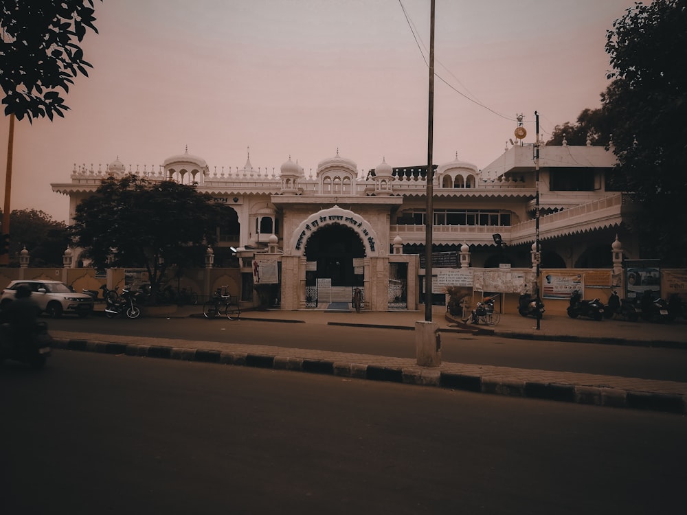 a large white building sitting on the side of a road