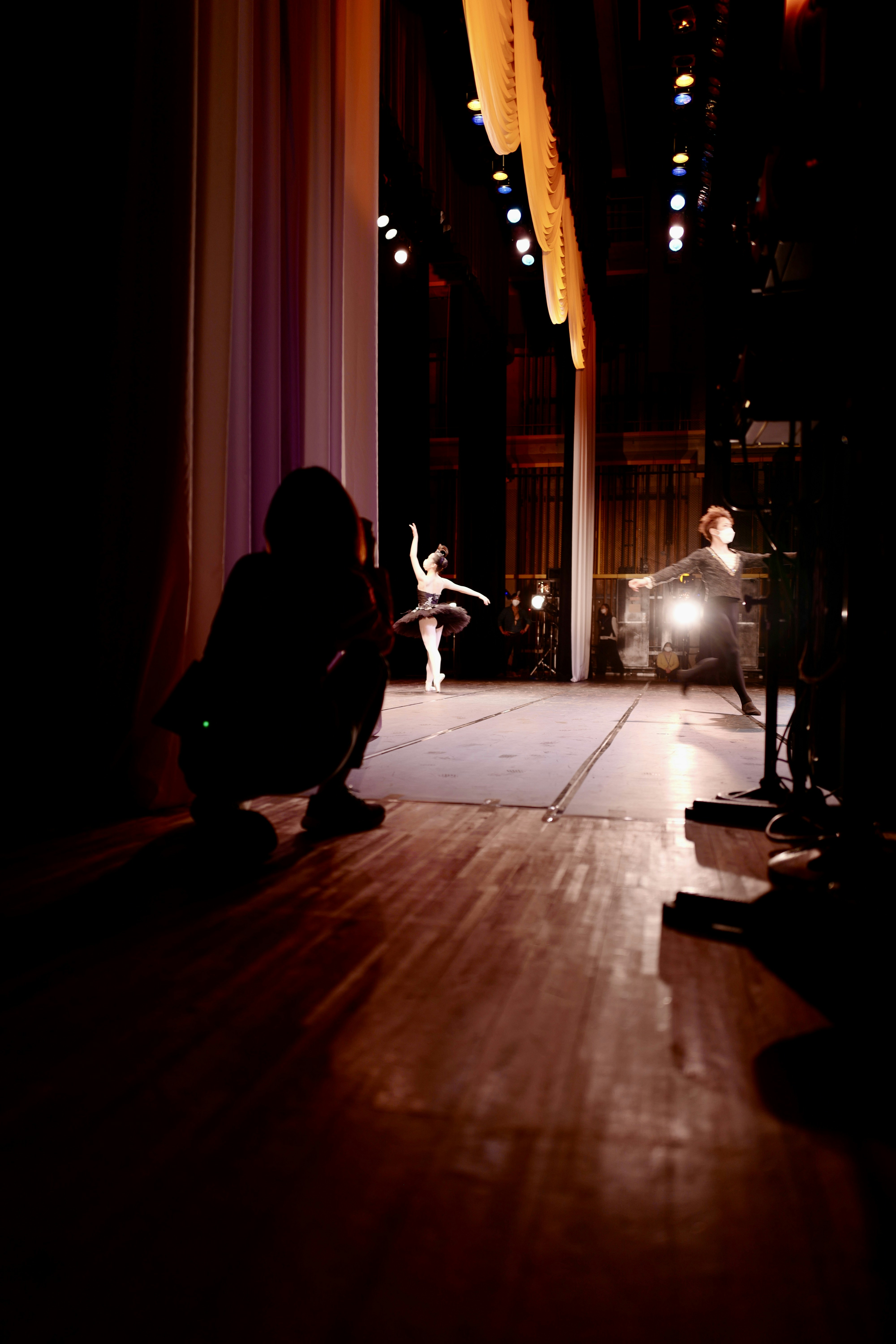 a person sitting on the floor in a dark room