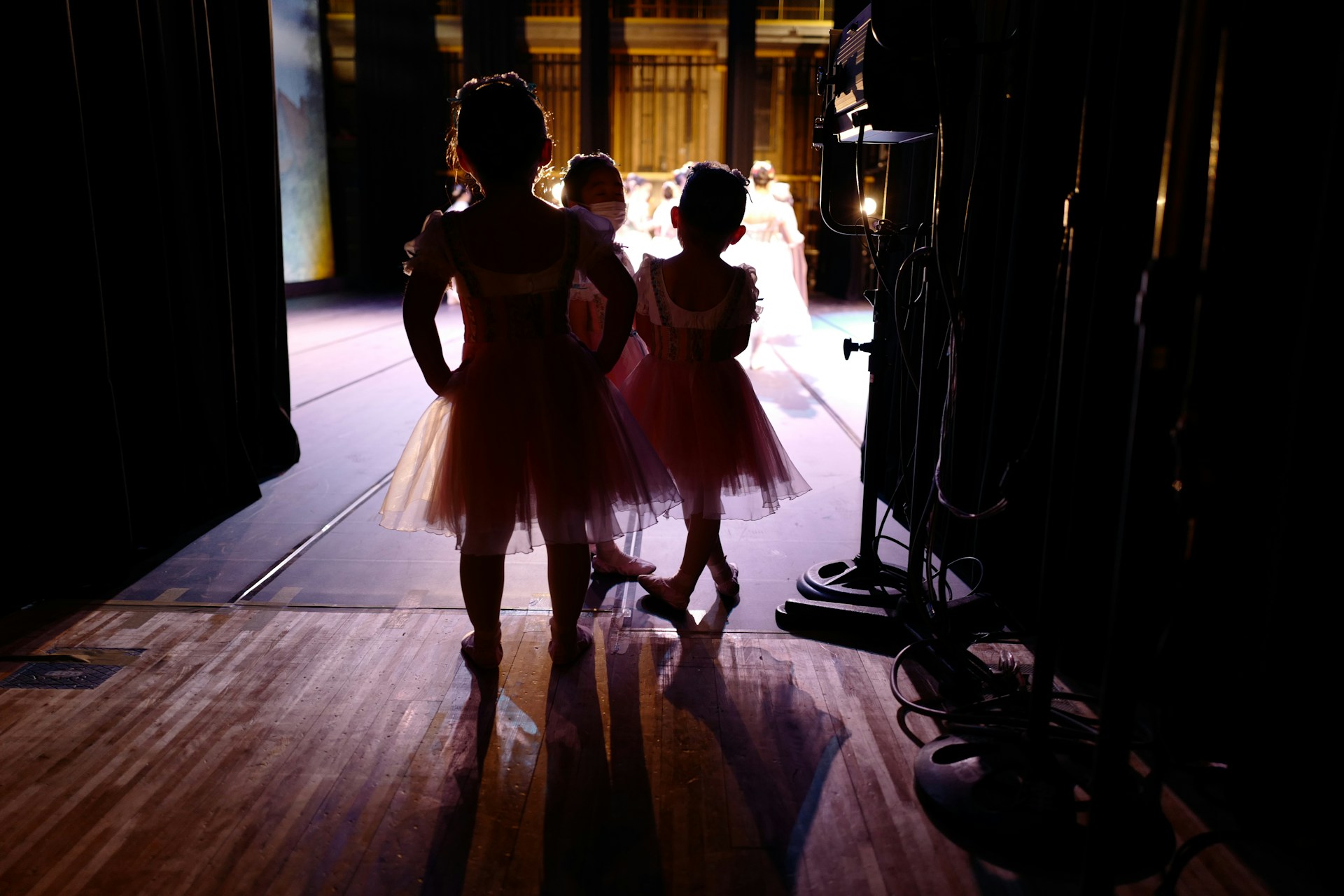 two young girls are standing on a stage