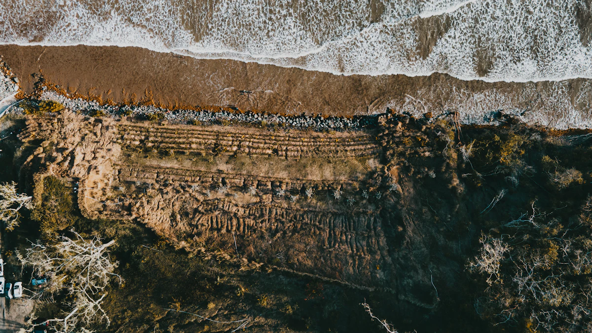 Top-down view of waves, a narrow beach and an eroded shoreline at Quinam Bay, Trinidad