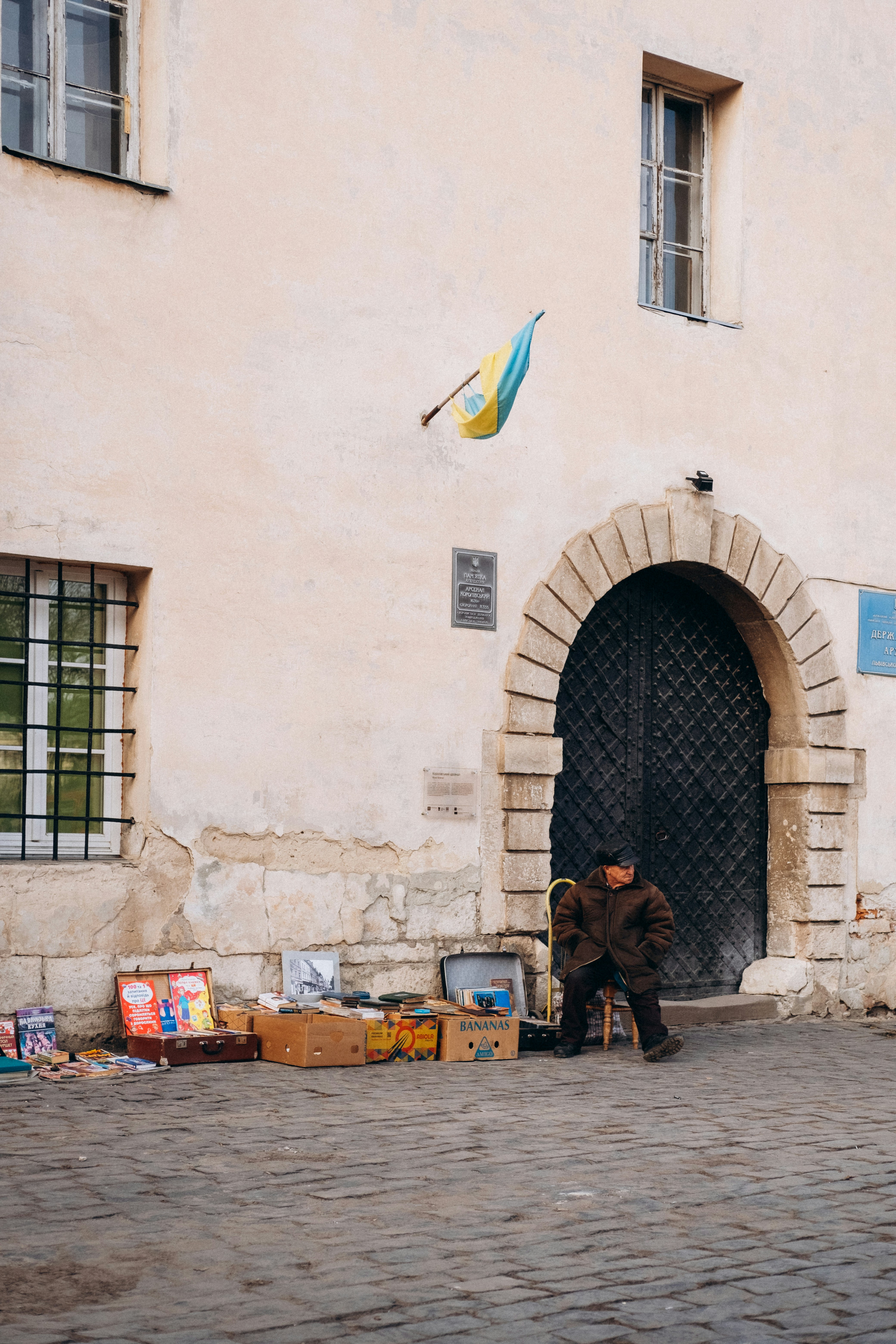 a man sitting on a chair in front of a building