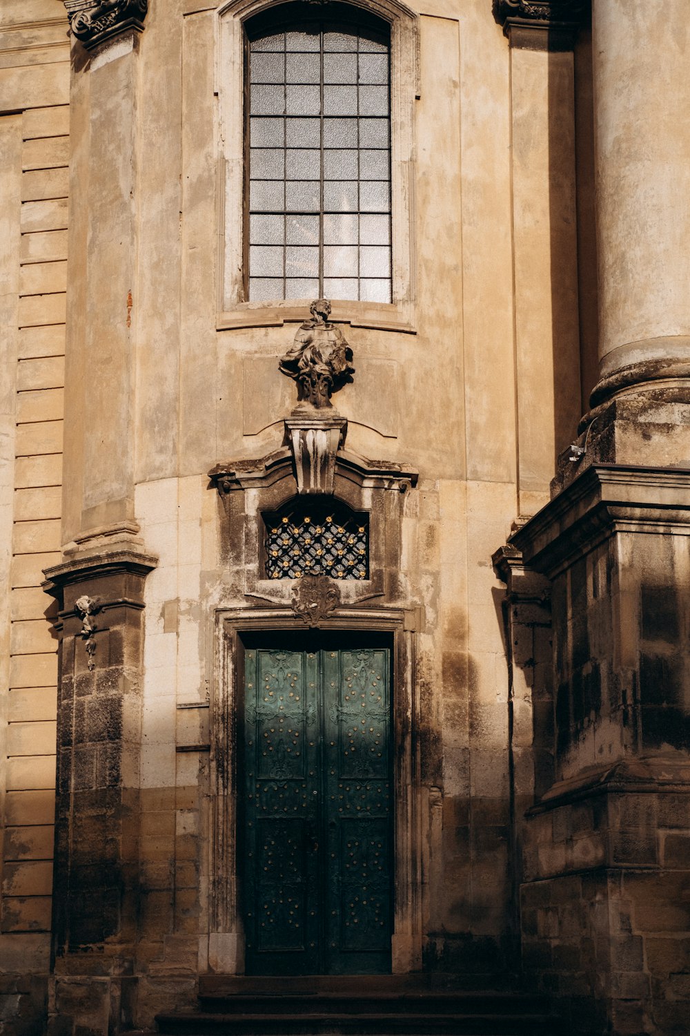 an old building with a green door and window