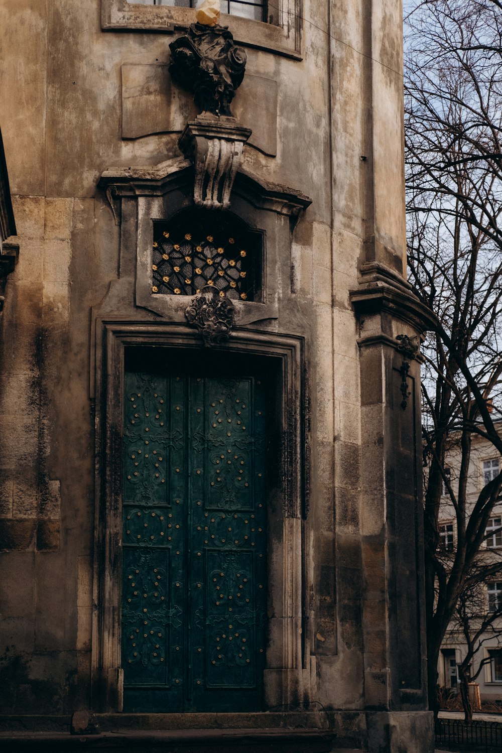 an old building with a green door and window