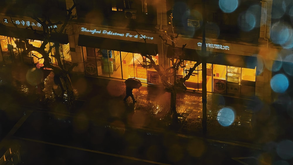 a person walking down a street holding an umbrella