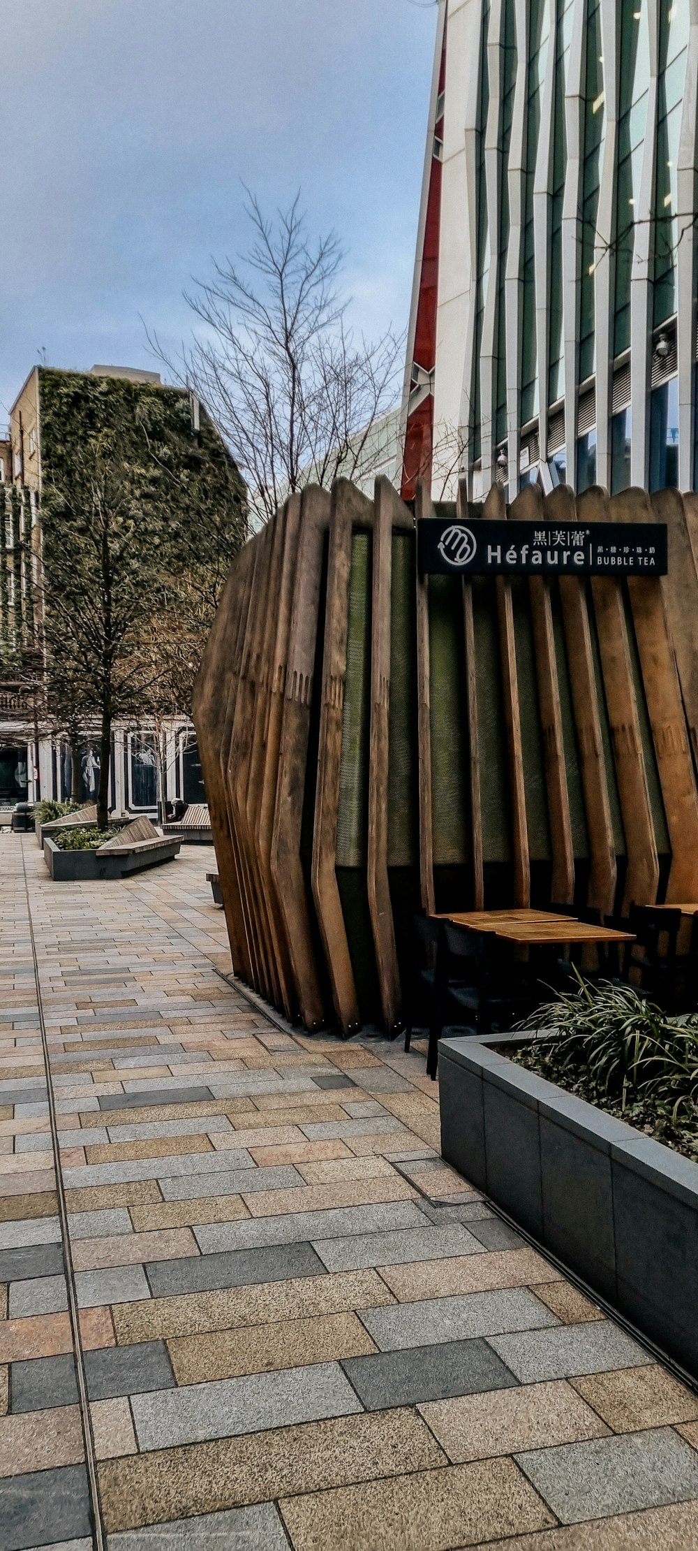 a large wooden sculpture sitting on the side of a road