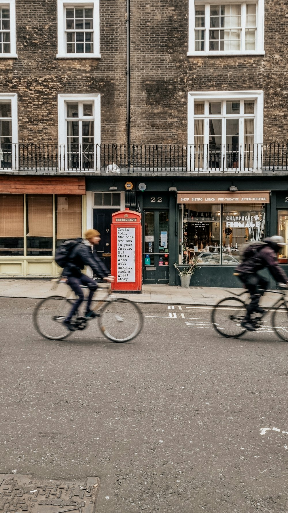 a couple of people riding bikes down a street