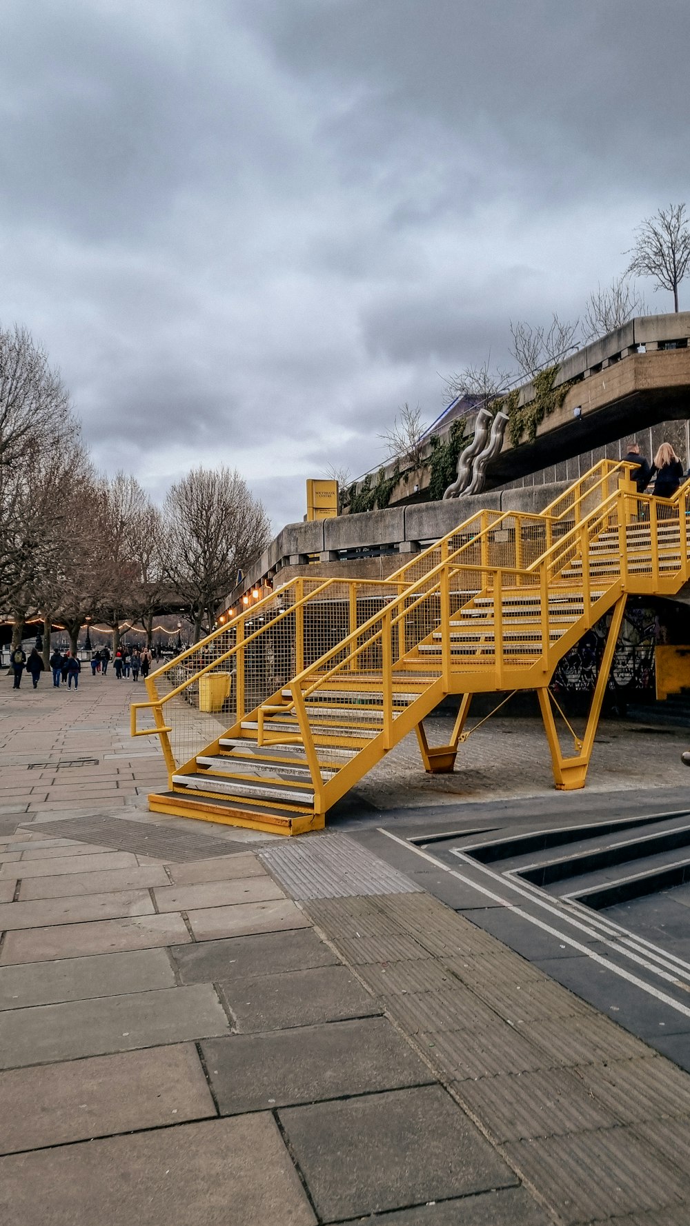 a yellow staircase going up to a building