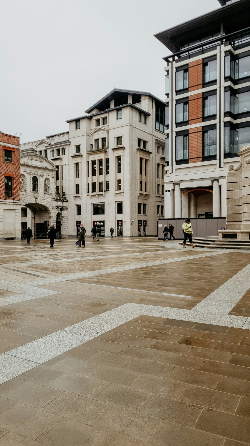 a group of people walking around a large courtyard