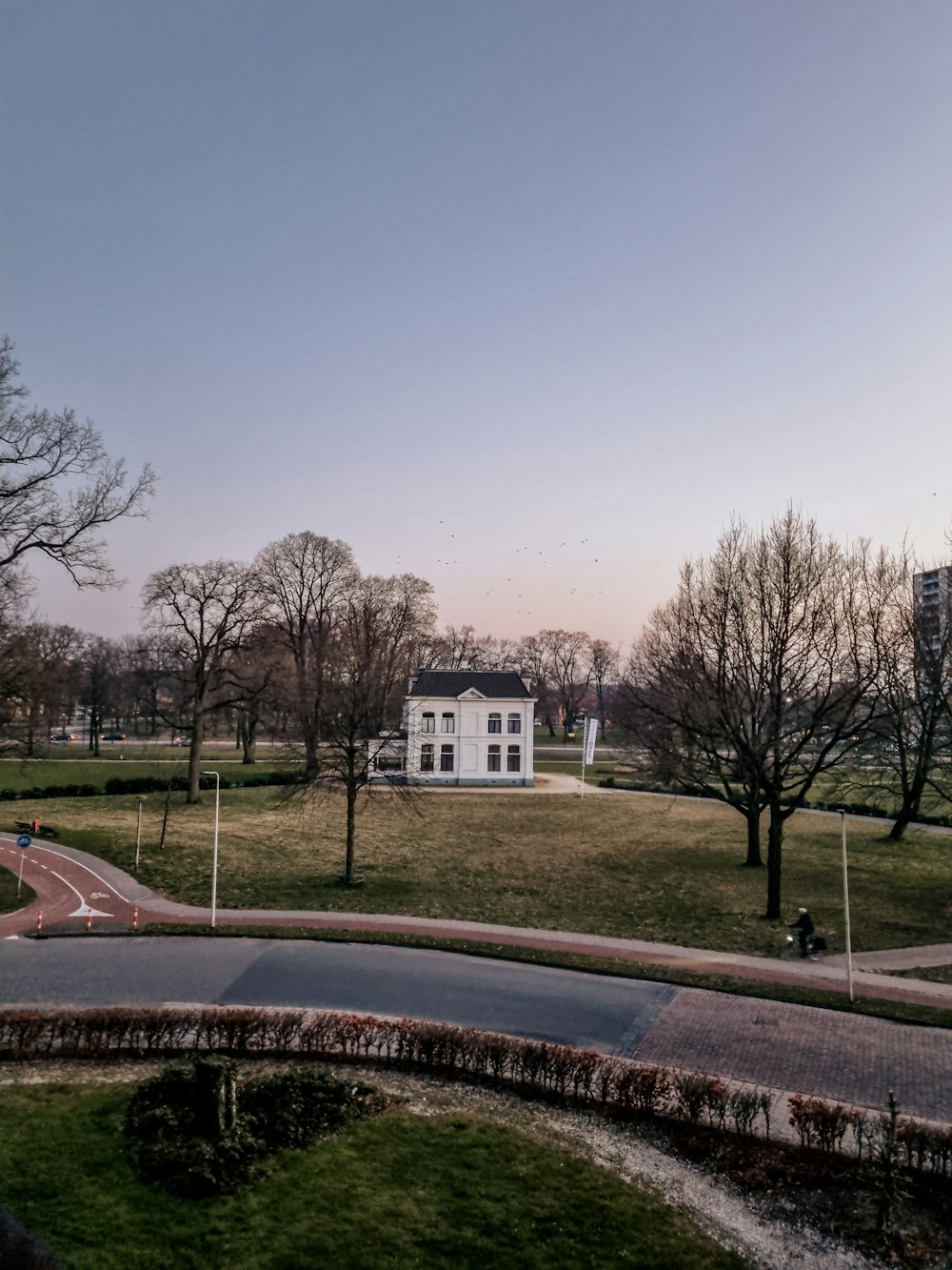 a white house sitting on top of a lush green field