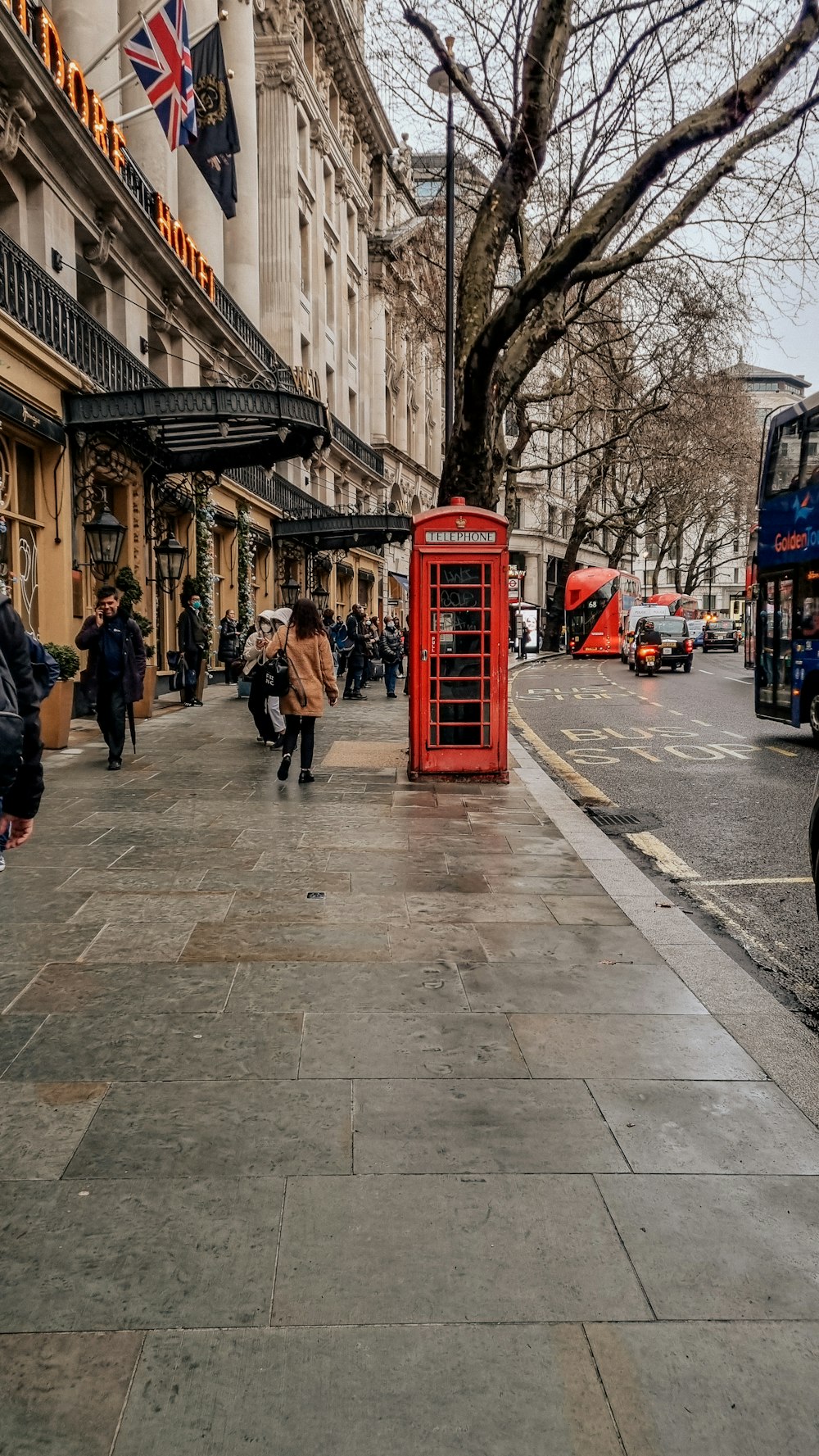 a red phone booth sitting on the side of a street