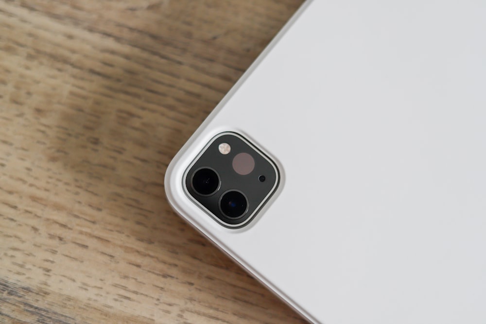 a close up of a cell phone on a wooden surface