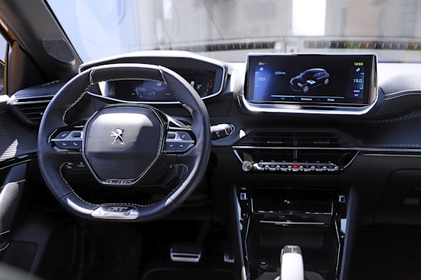 the interior of a car with a steering wheel and dashboard