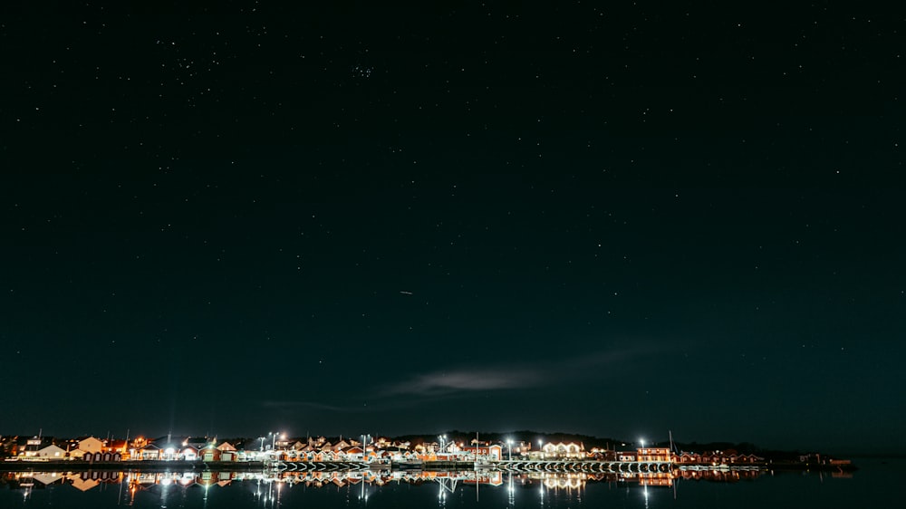a night time view of a city and a body of water