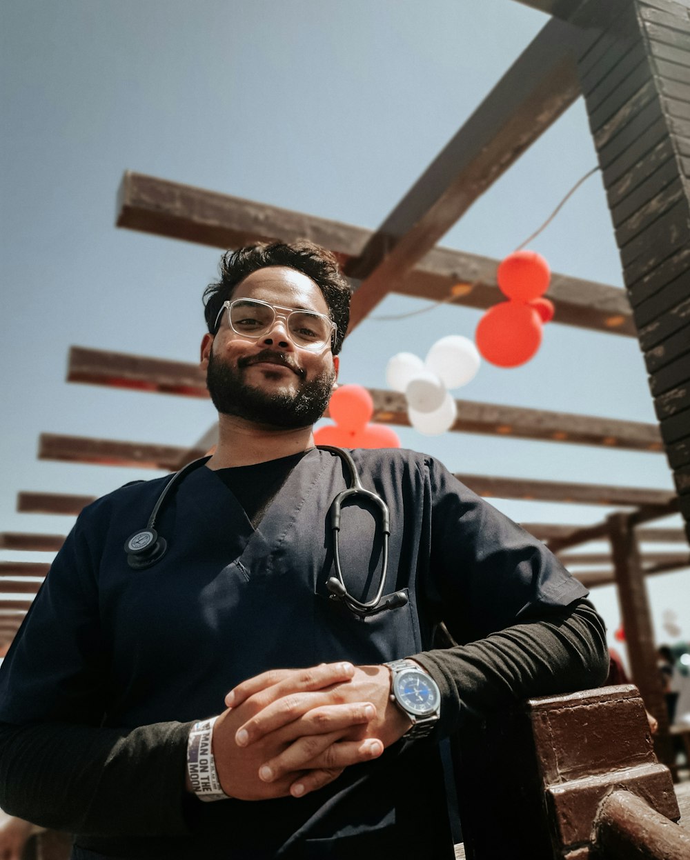 a man with a stethoscope standing in front of a building