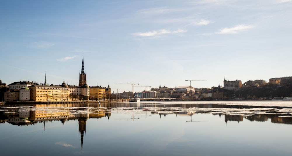 a large body of water with buildings in the background