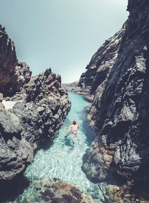 Swimmers powering through turquoise ocean waters near El Arco at sunrise