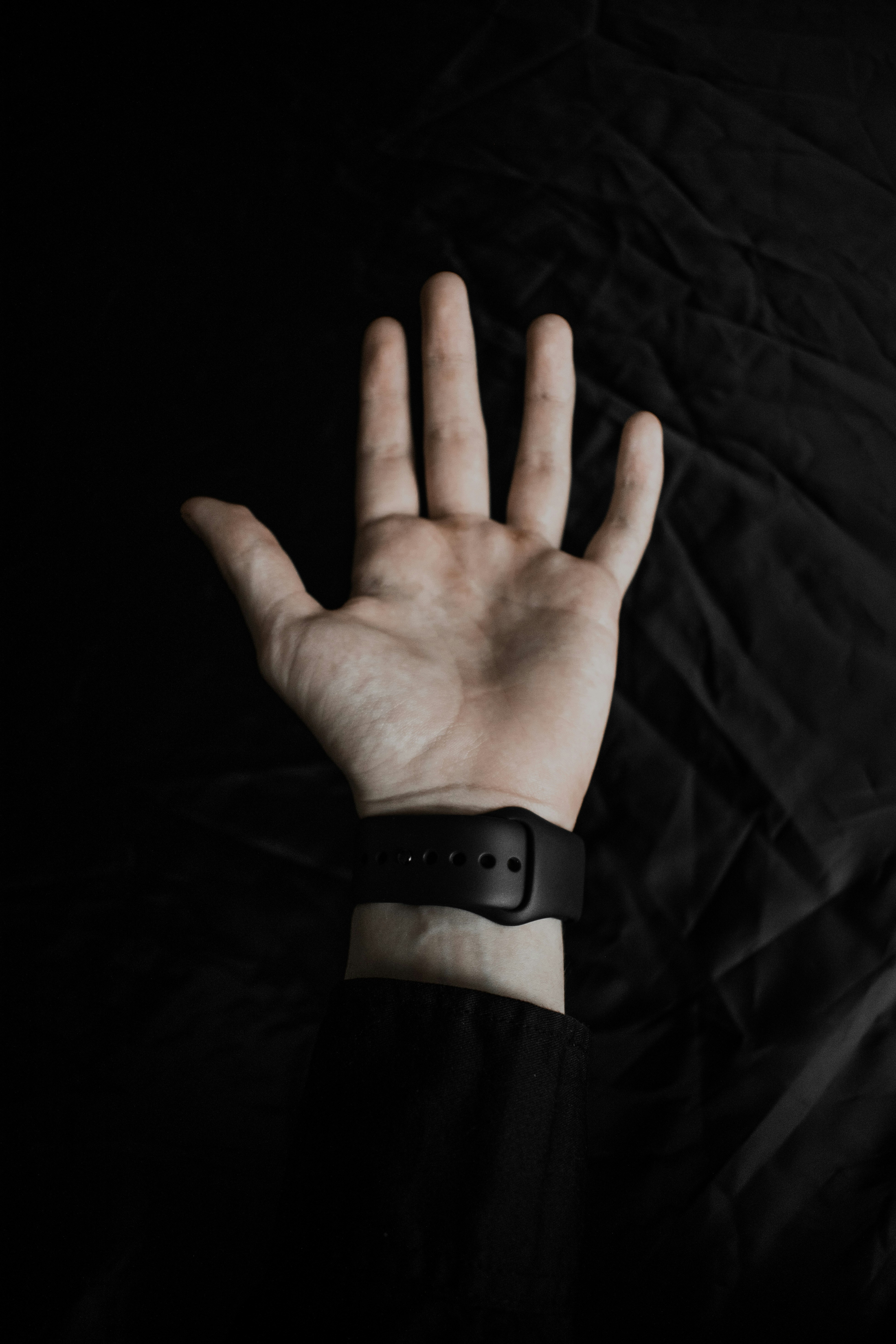 a person's hand with a wrist band on it