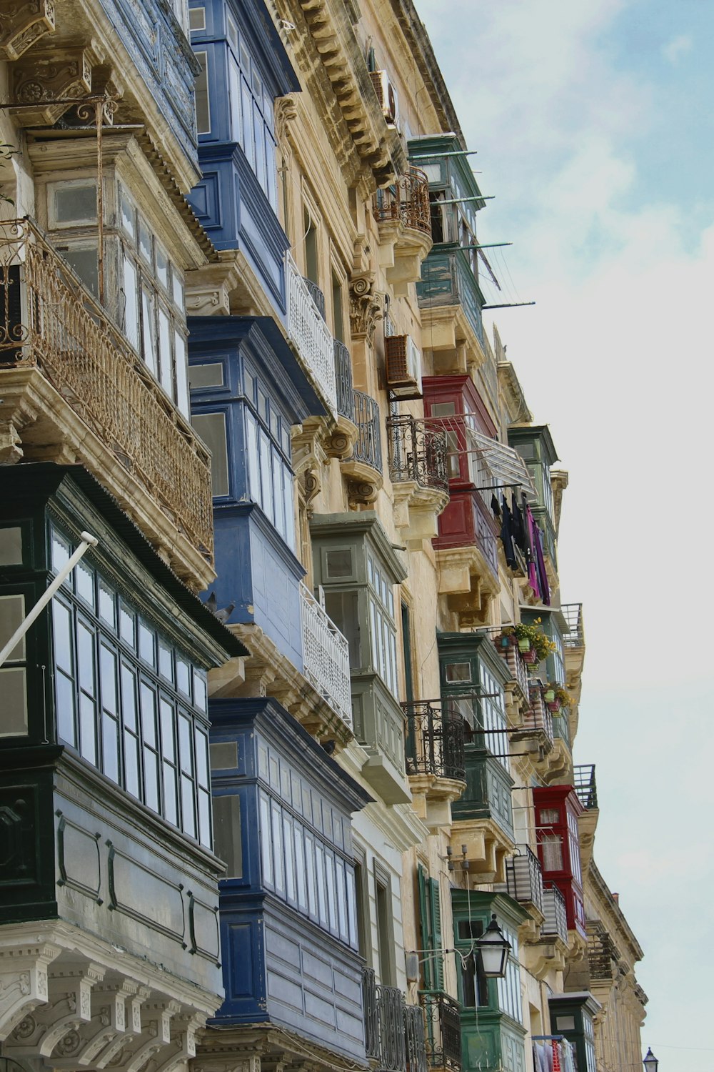 a row of multi - colored buildings with balconies and balconies on