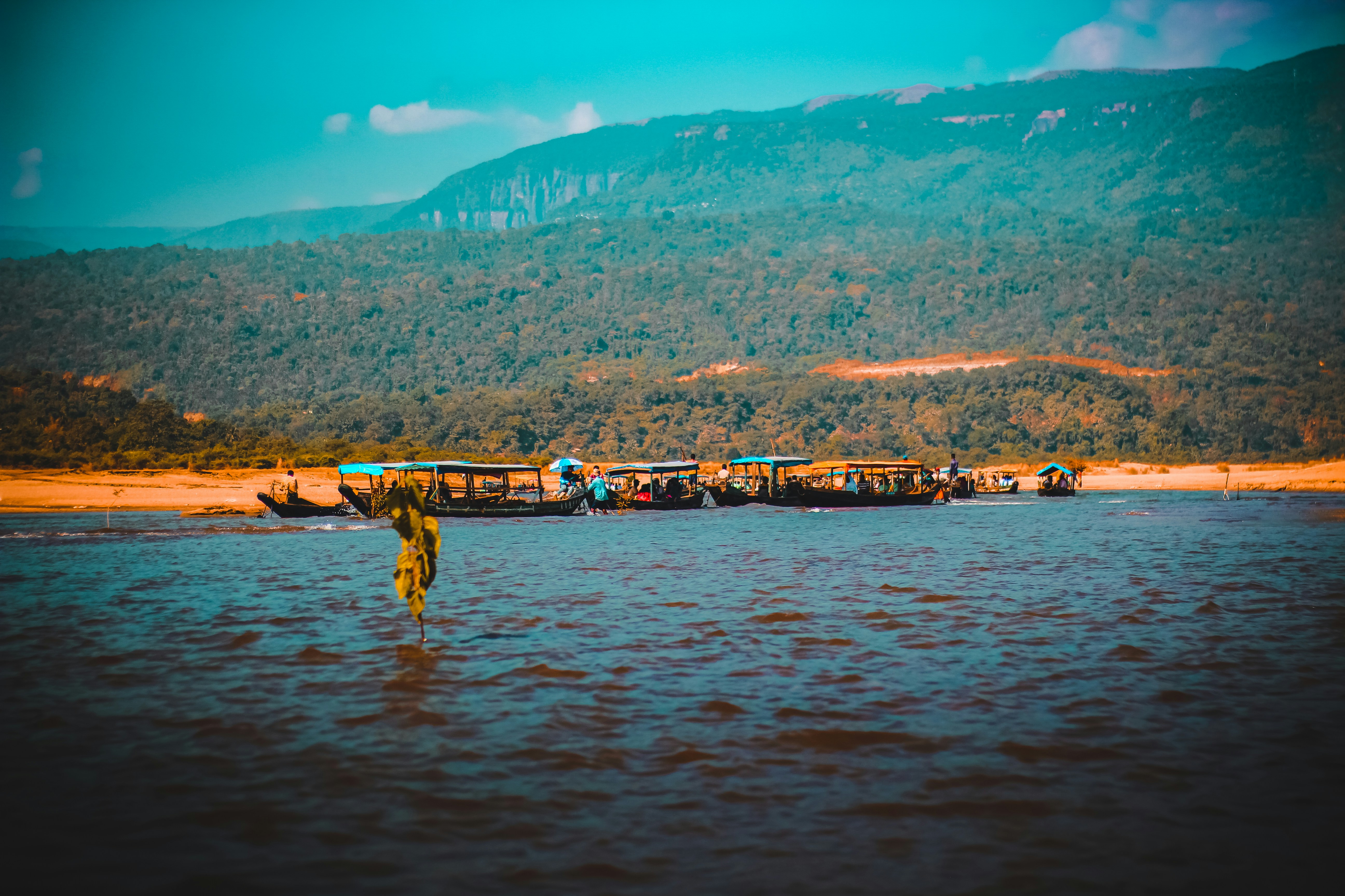 a person standing in the water with a boat in the background