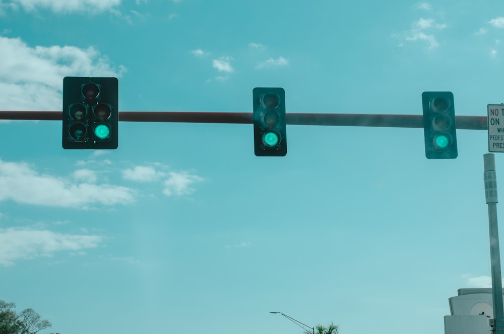 a couple of traffic lights hanging from a metal pole