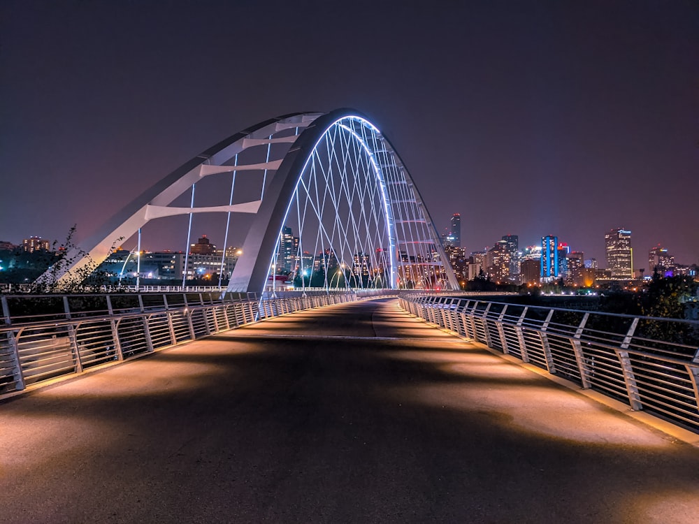 a bridge with a city skyline in the background